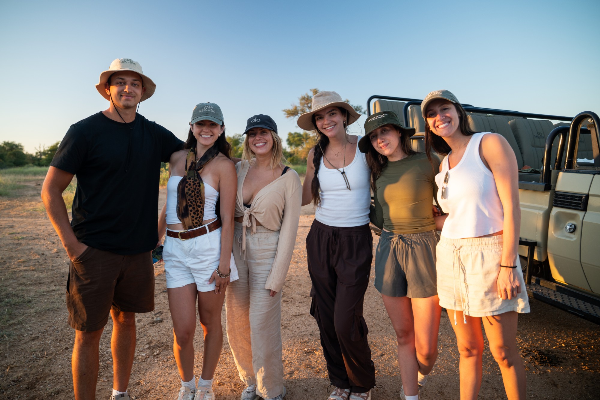 Guests together at the vehicle on a Kismet Collection retreat